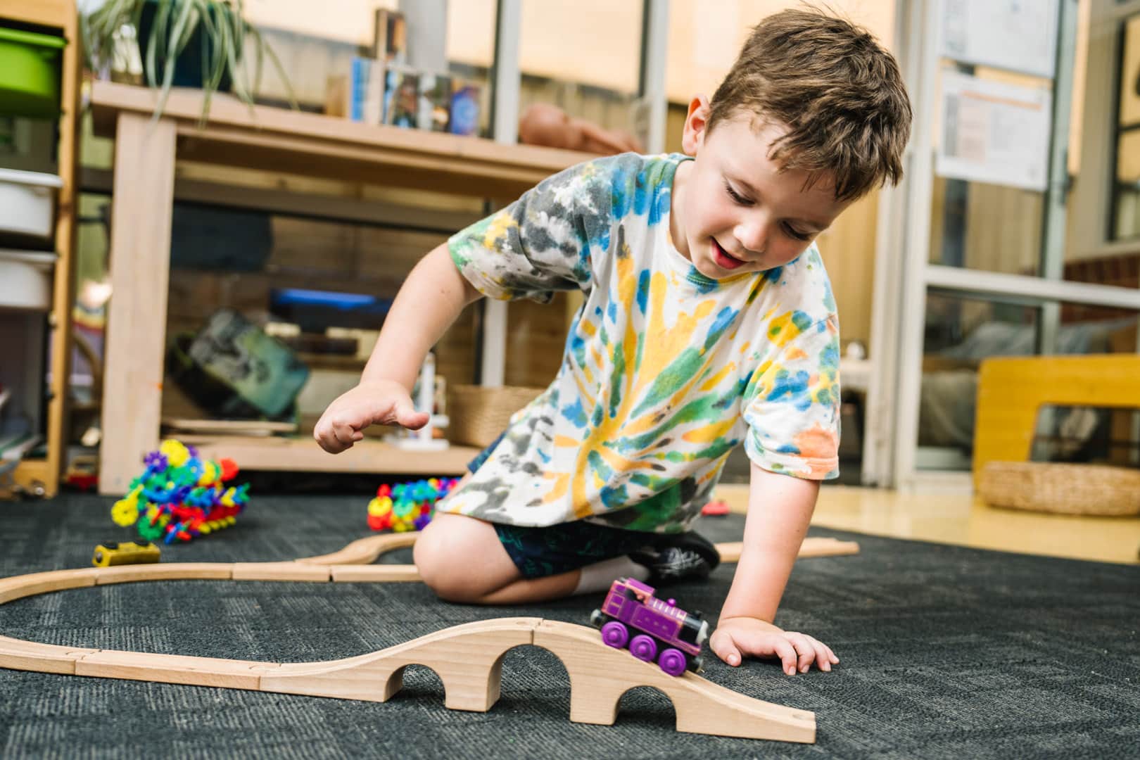 Child playing with train set at Alfred Childcare in Melbourne