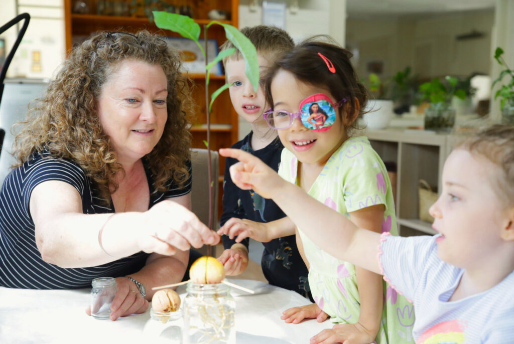 Educator interacting with children at KU Sunbeam childcare in Alexandria