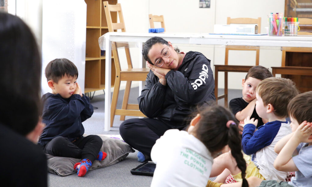 Educator interacting with children at KU Sunbeam childcare in Alexandria