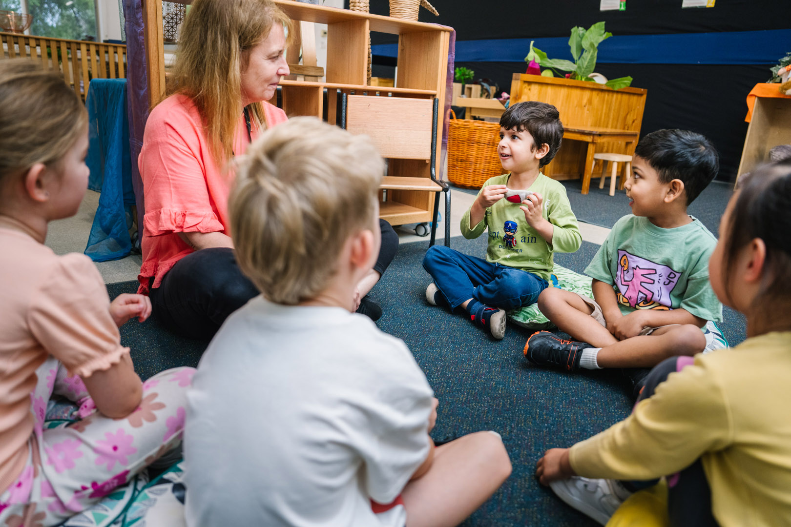 Childcare educator engaging with children at Armstrong Creek chilcare