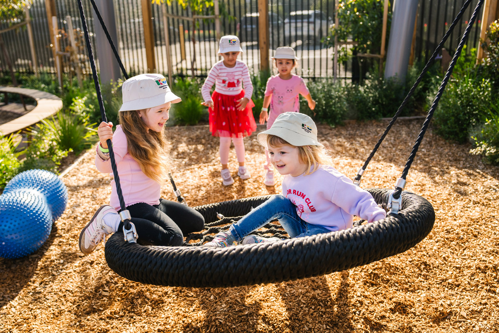 Children playing on outdoor equipment at Biyala Kindergarten in Armstrong Creek