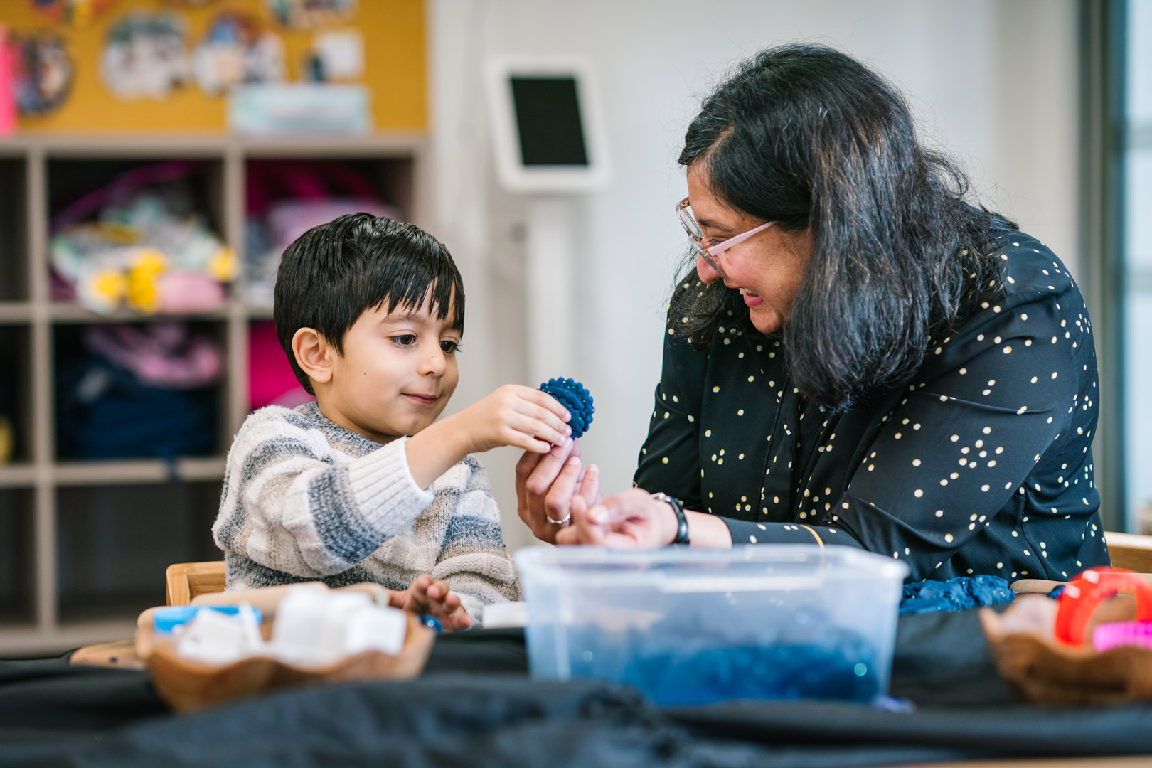 Educator at Armstrong Creek kinder engaging with child