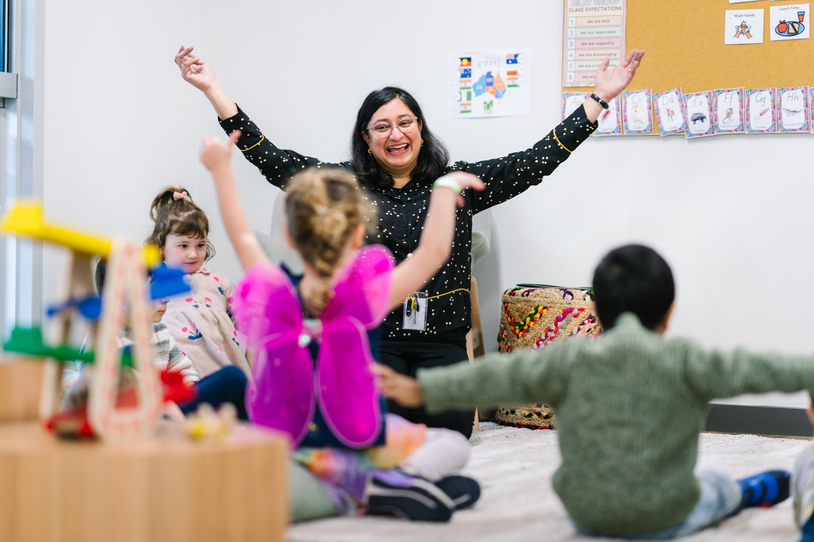 Educator engaged with children at Armstrong Creek Kinder