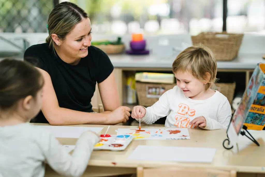 KU Ashmont educator painting with a child