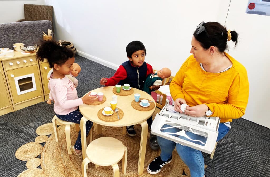 KU Ashmont educator and some children having a tea party
