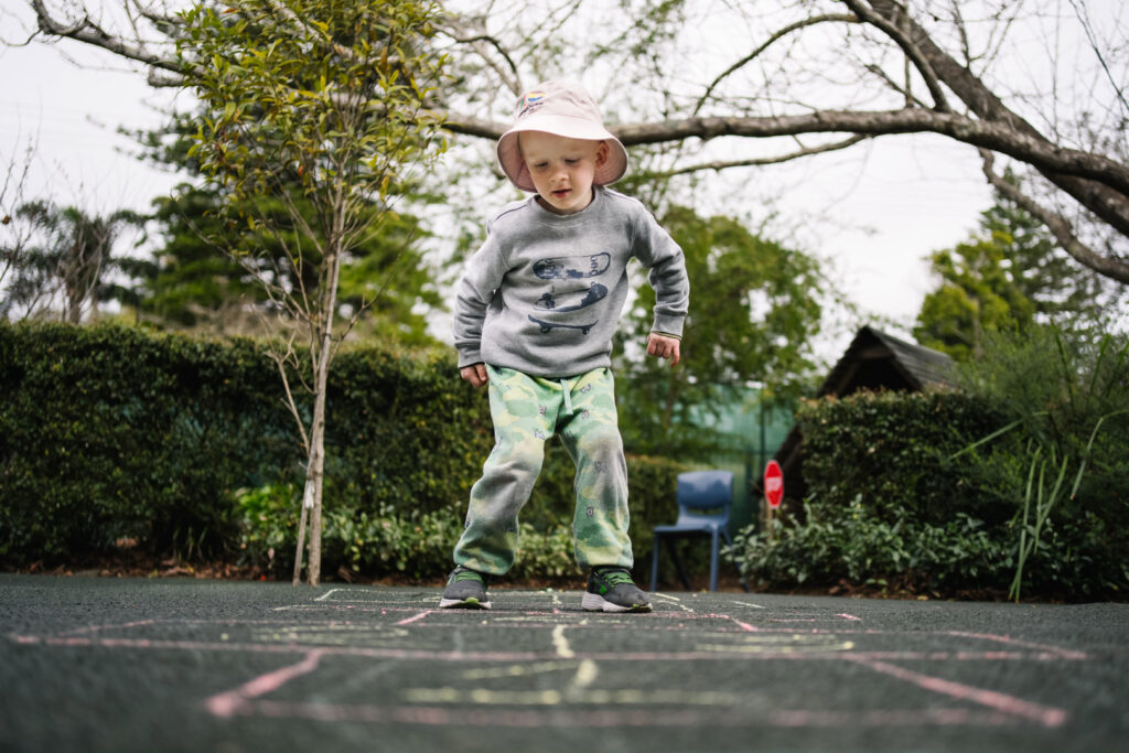 Child playing hopscotch at KU Berowra childcare
