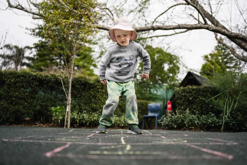Child playing hopscotch at KU Berowra childcare