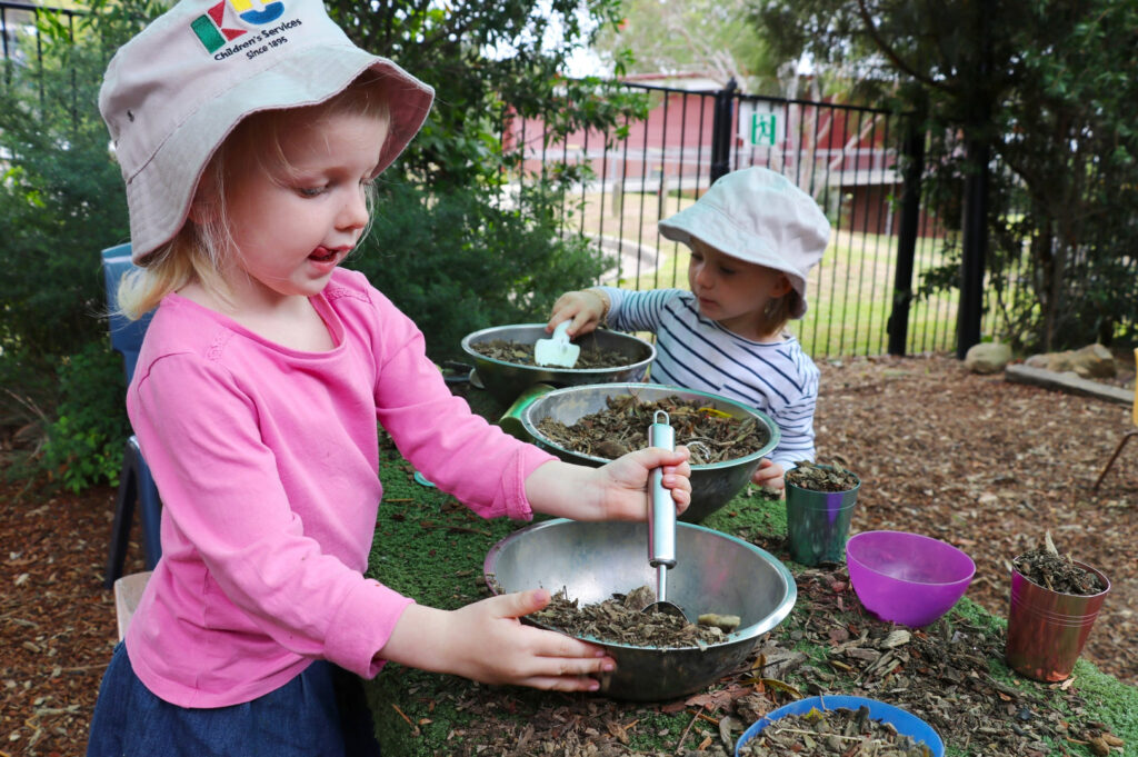 Children playing in the outdoor kitchen at KU Berowra childcare