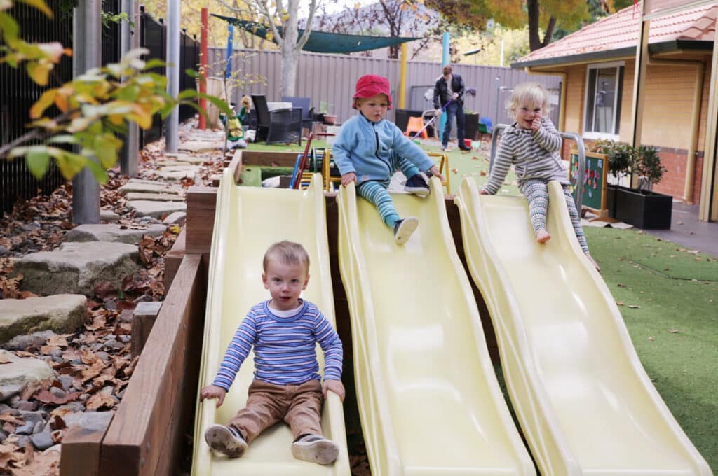 Children playing on the slides at KU Braddon childcare