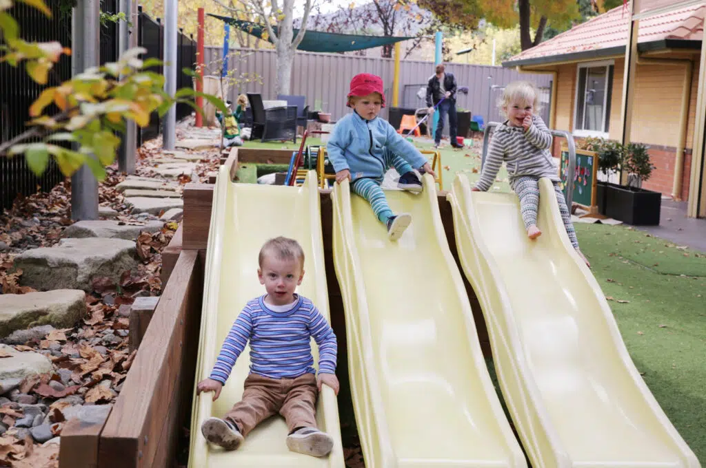 Children playing on the slides at KU Braddon childcare