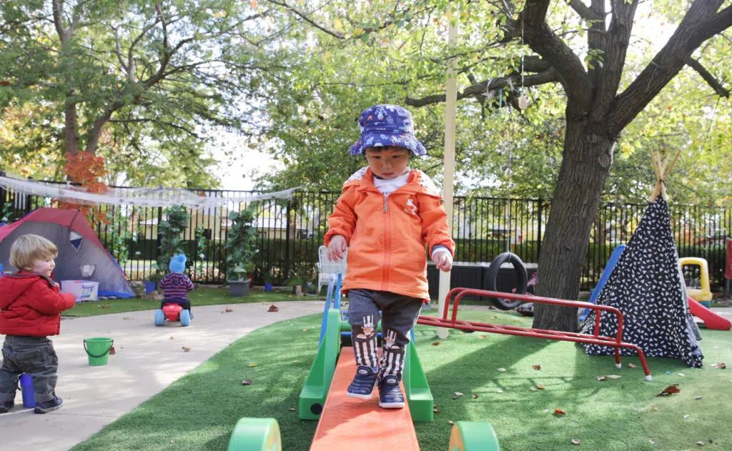 Child walking on a balance beam at KU Braddon childcare
