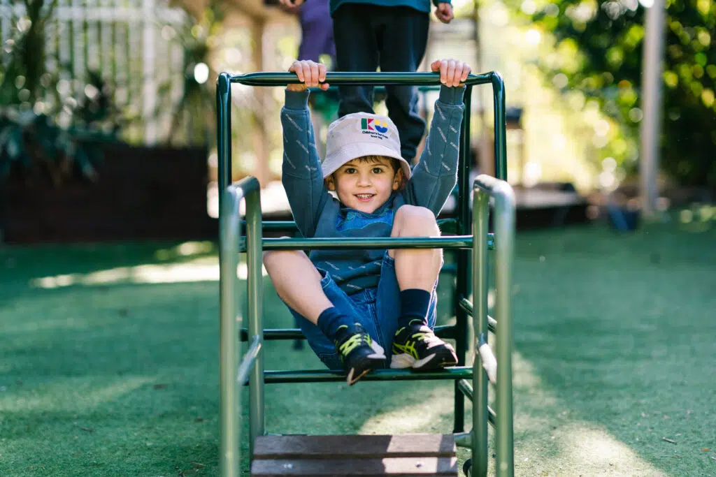 Child playing on equipment at KU Bulli childcare
