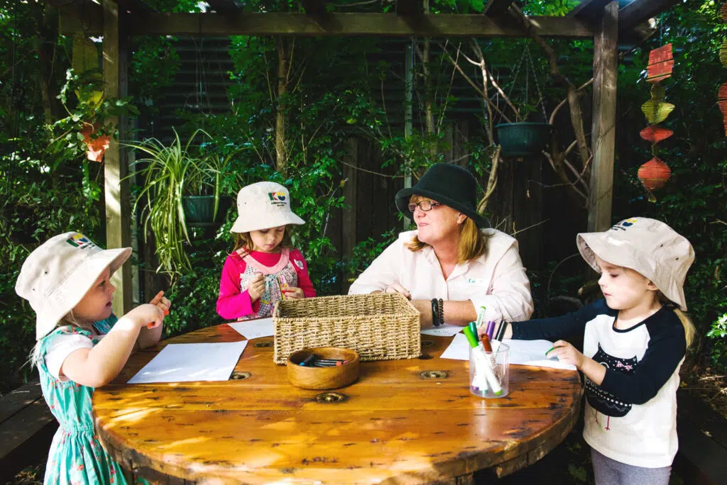 KU Burwood childcare educator and children doing some drawings