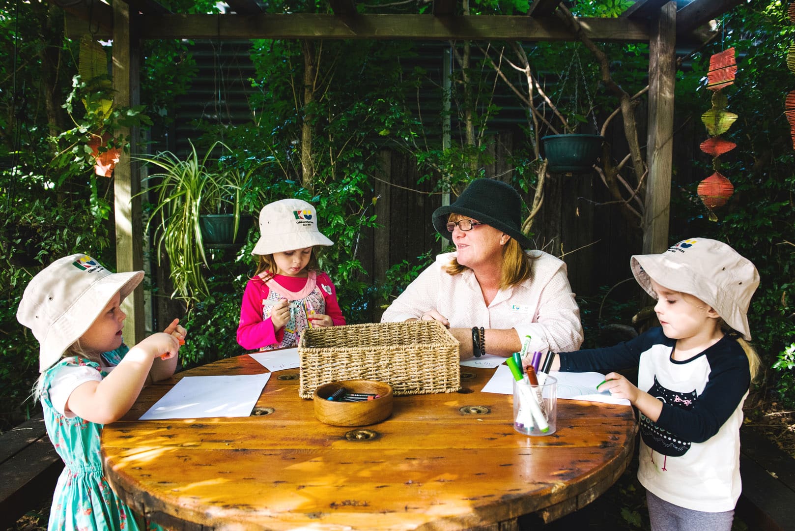 KU Burwood childcare educator and children doing some drawings
