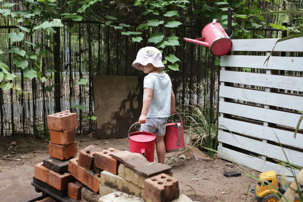 A child watering the plants at Kooinda Workbase Childcare