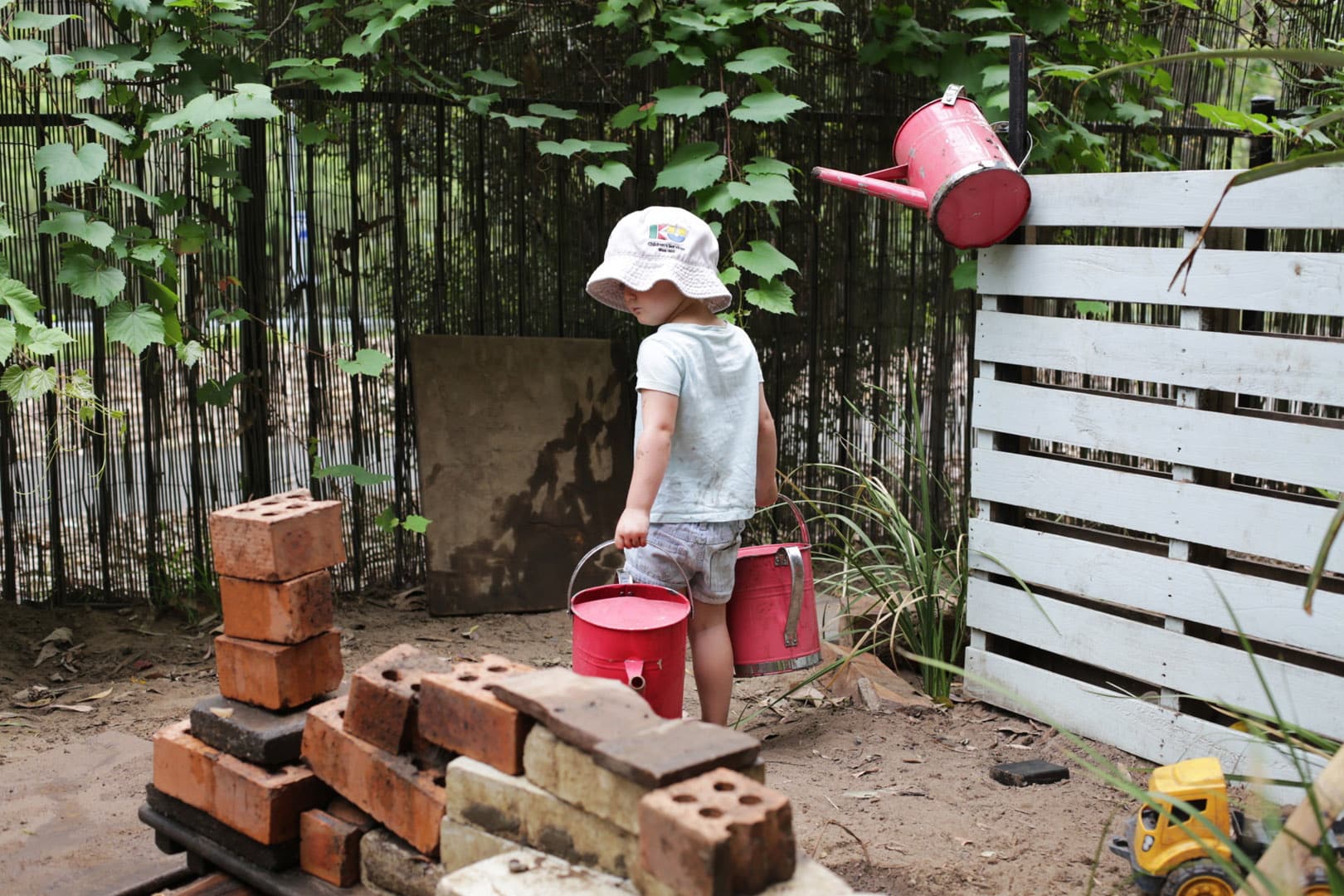 A child watering the plants at Kooinda Workbase Childcare