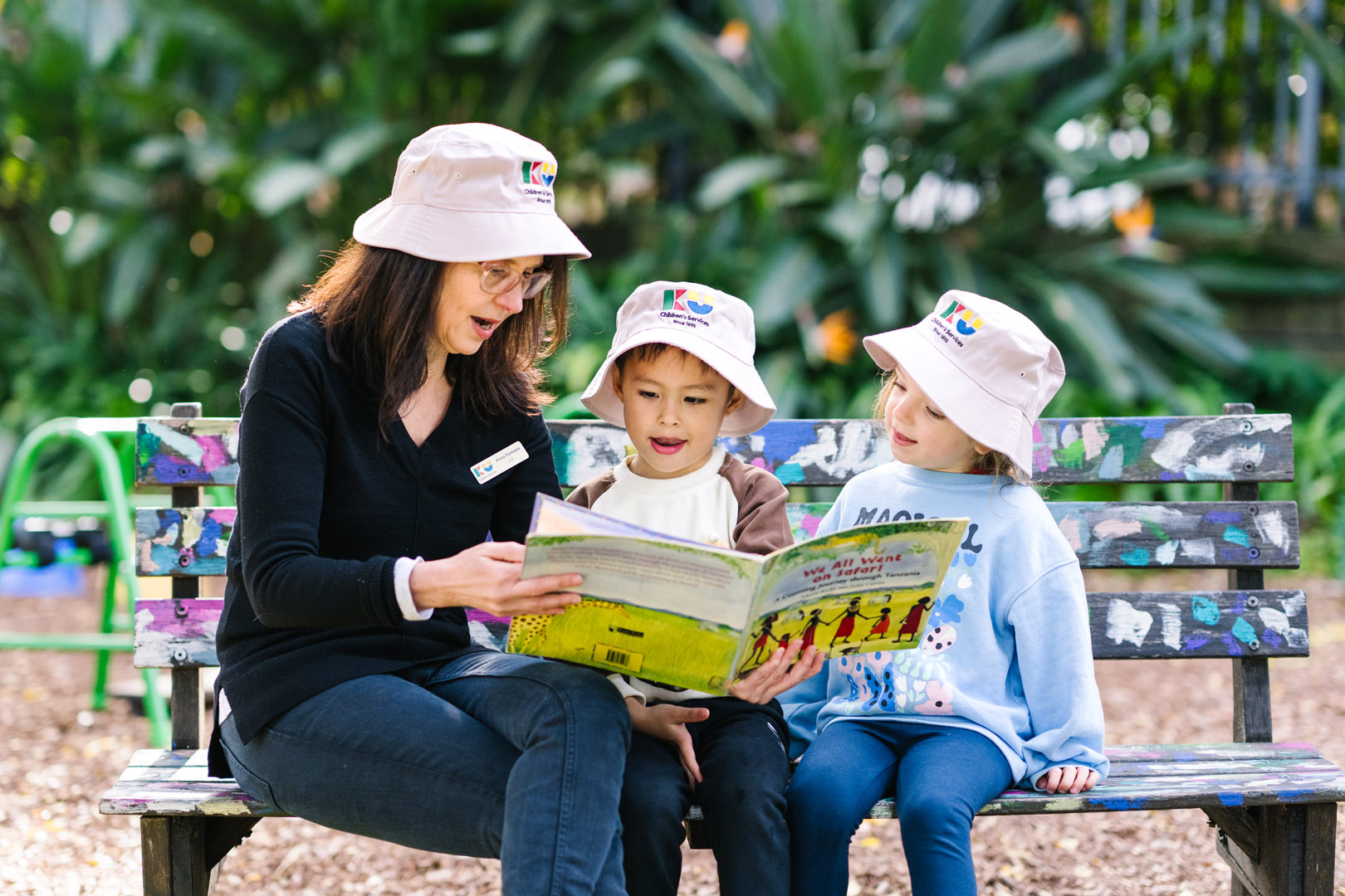 Children reading with educator at Castlecrag childcare