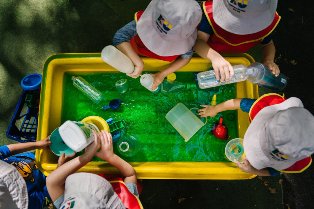 Children playing with water at KU Chatswood Community childcare