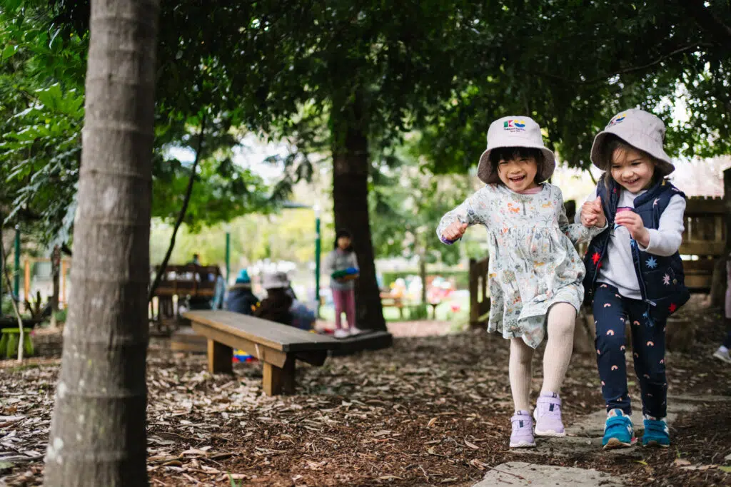 Children playing outdoors at KU Cheltenham Memorial childcare