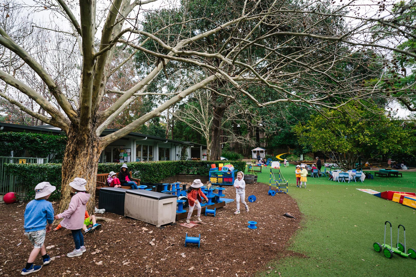 Children playing outdoors at KU Cheltenham Memorial childcare