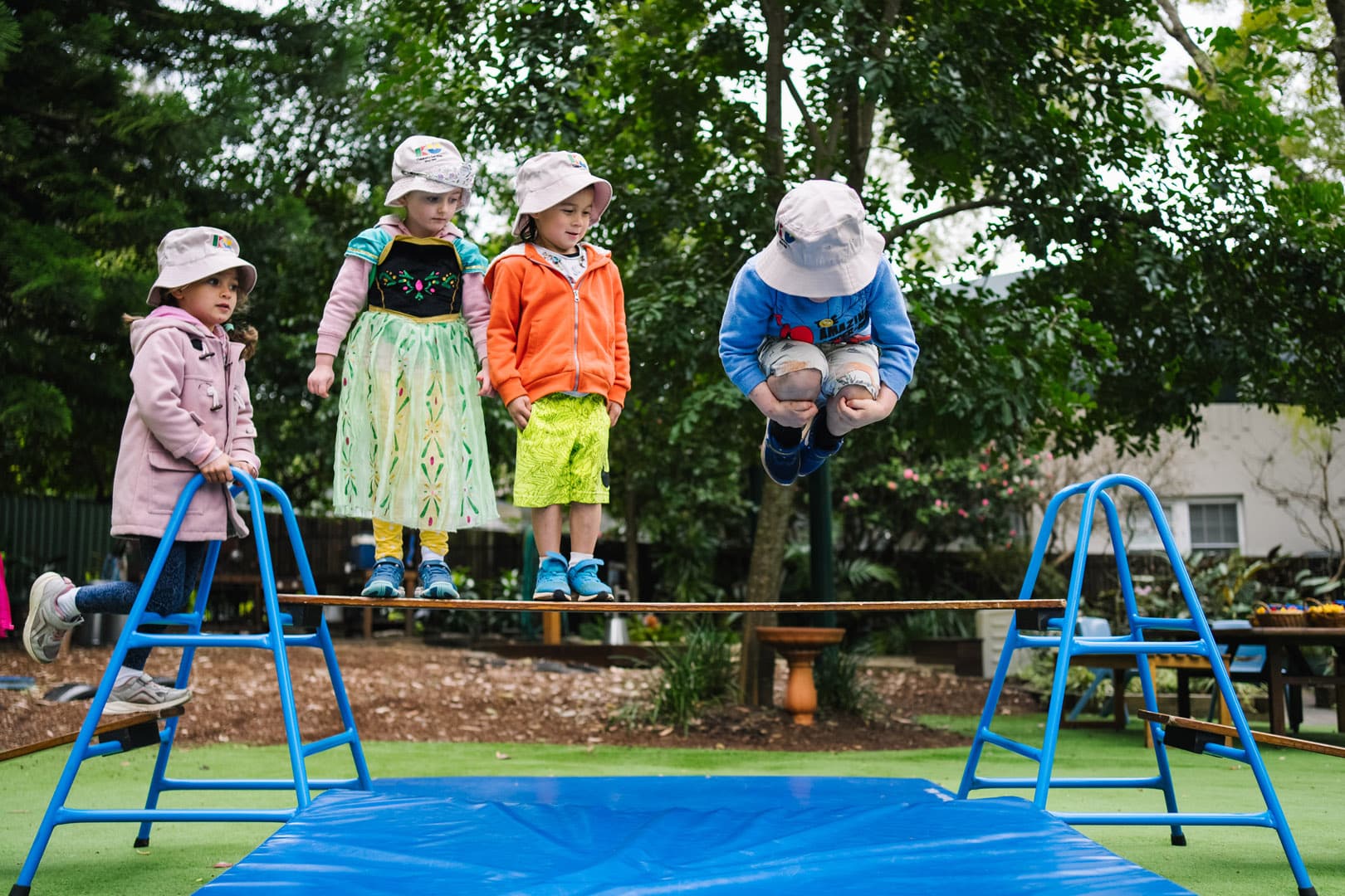 Children playing on equipment at KU Cheltenham Memorial childcare
