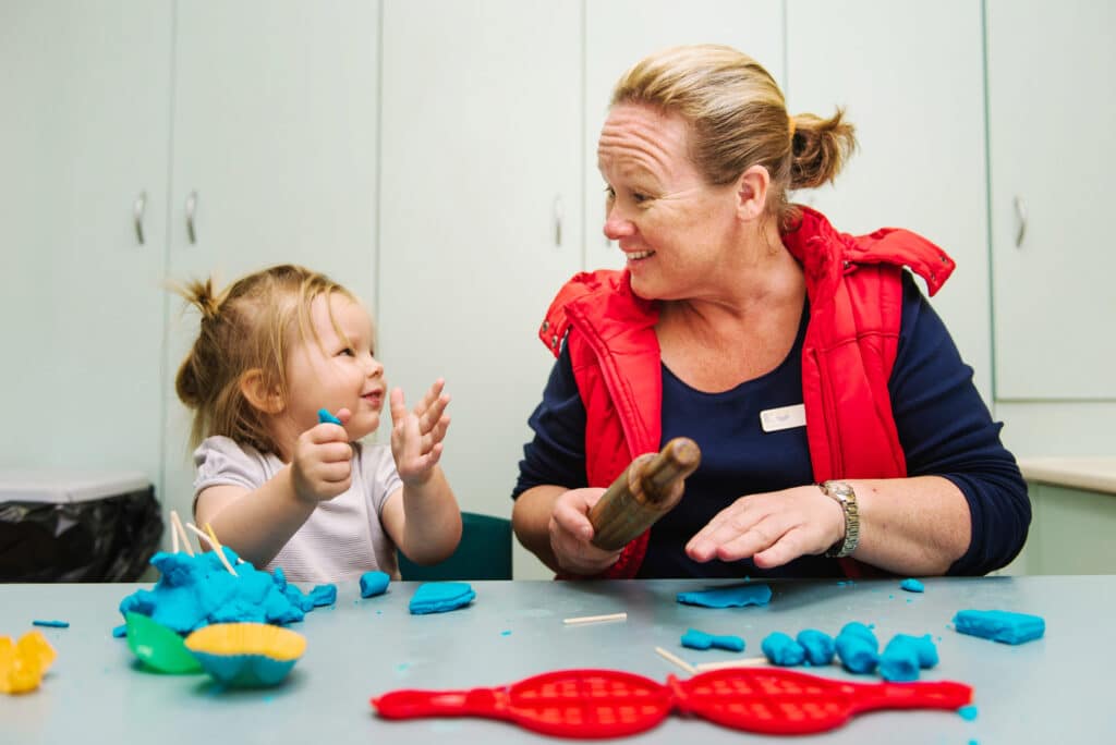KU Cobbitty childcare educator and a child sculpting with playdough