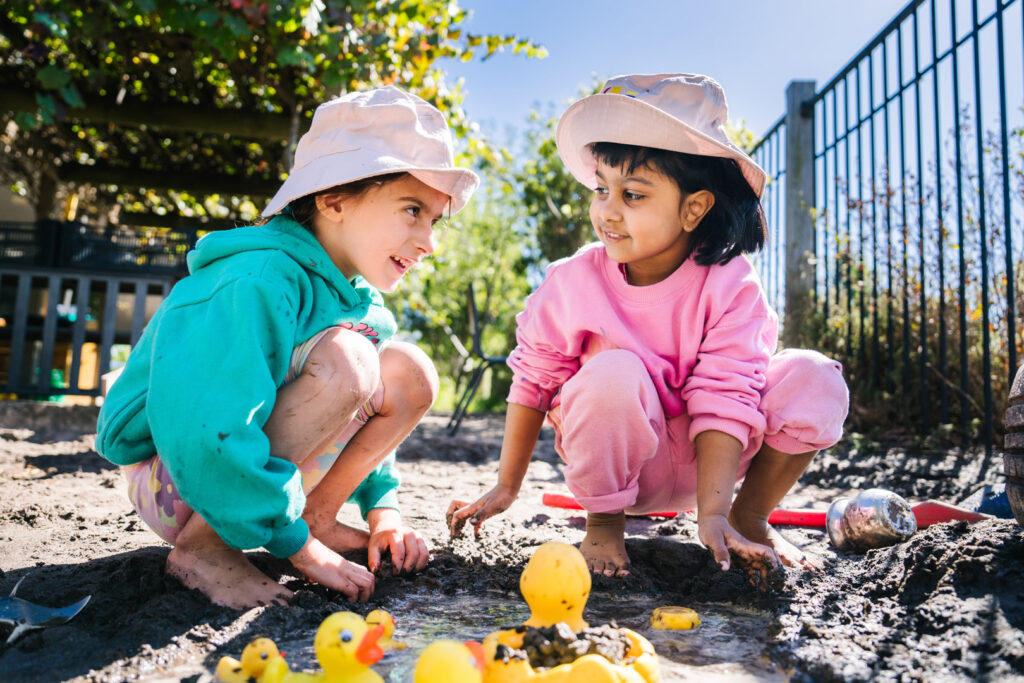 Children playing in mud pit at KU Craigieburn Childcare