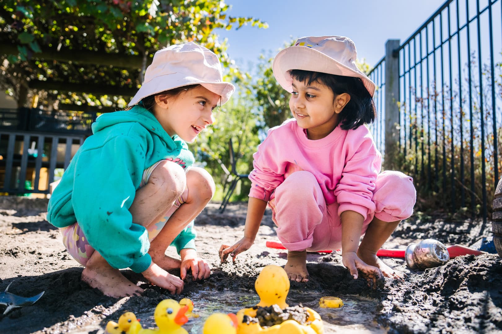 Children playing in mud pit at KU Craigieburn Childcare