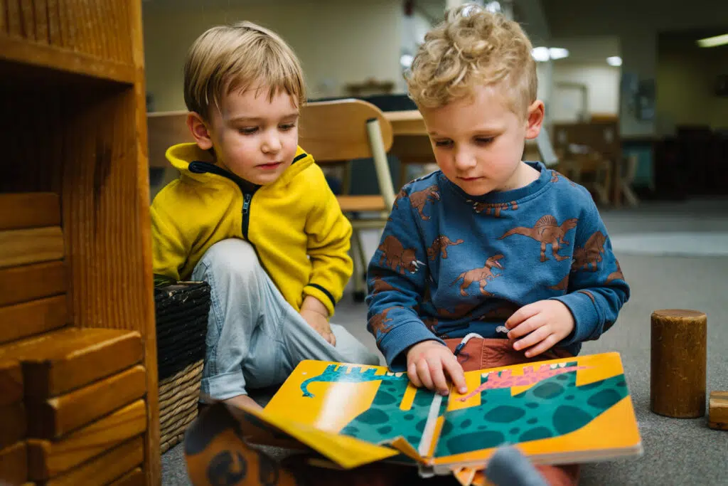 Children reading a story together at KU Union childcare