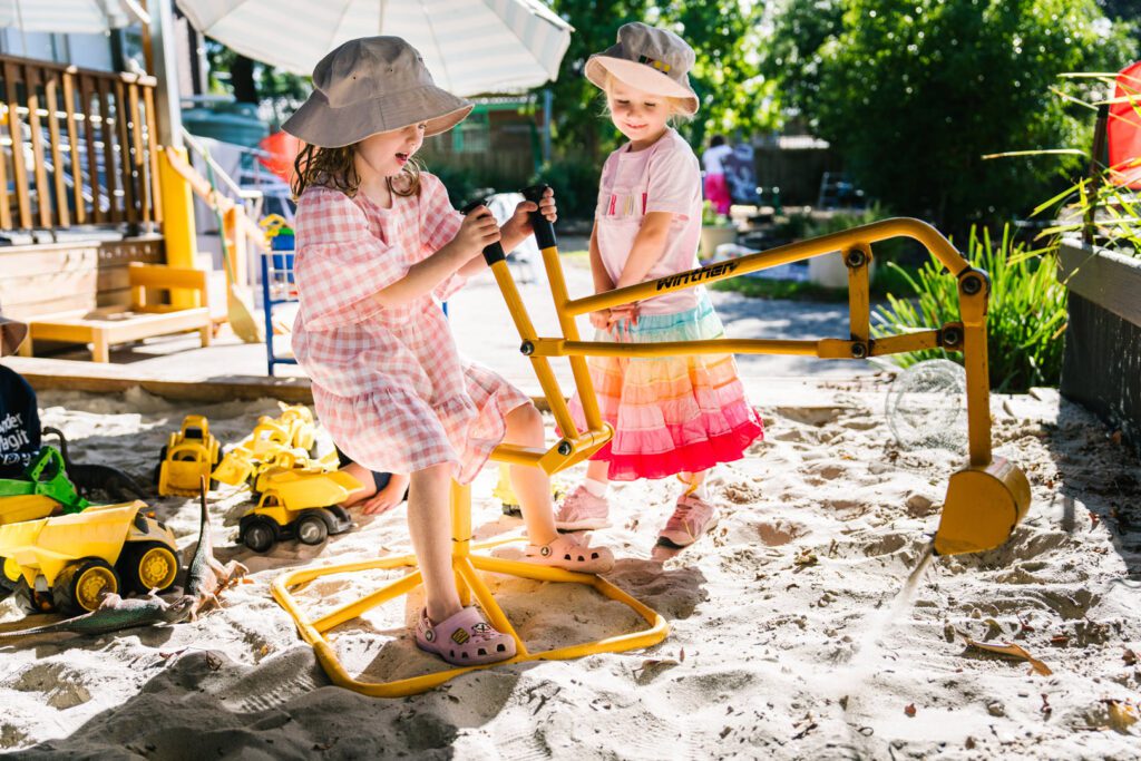 Children playing outdoors in sandpit at Alexander Magit Kindergarten in Ferntree Gully