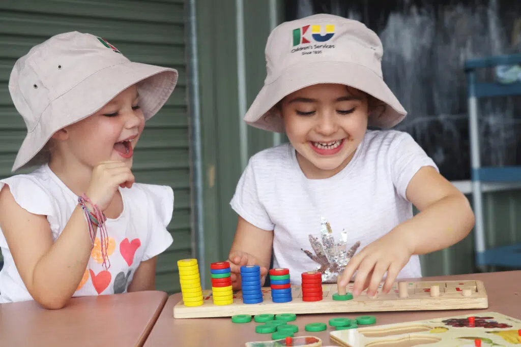 Children playing with colourful blocks at KU Figtree childcare
