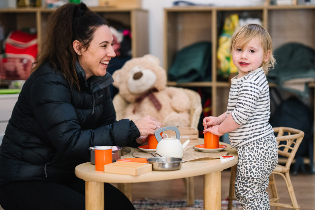 KU Monash childcare educator and child having a tea party