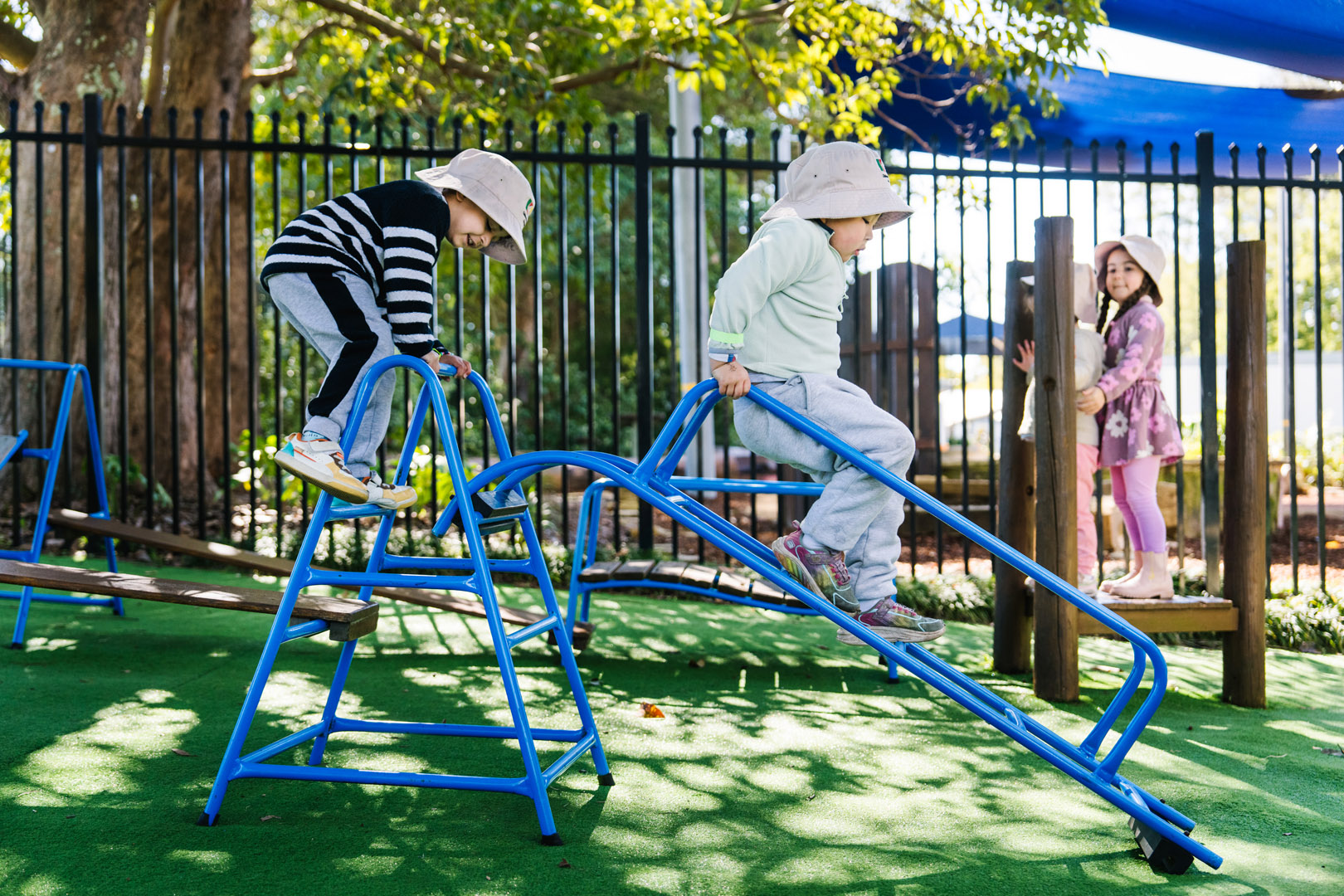 Children on play equipment at KU Galston childcare