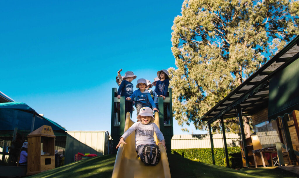 Children playing on the slide at KU Karingal childcare
