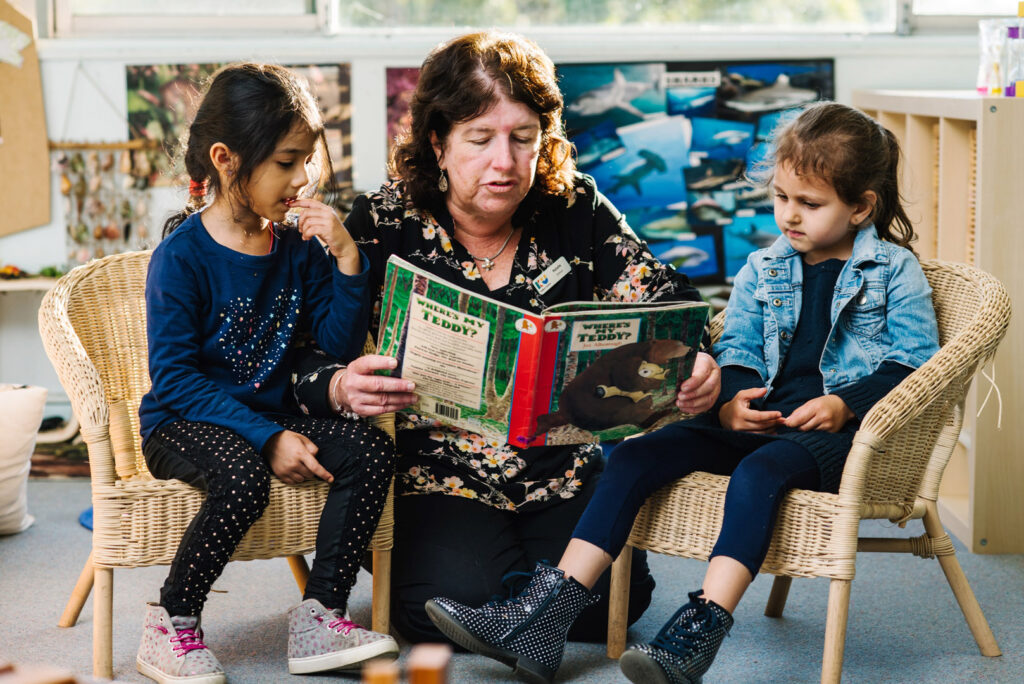 KU Karingal childcare educator reading a story to children