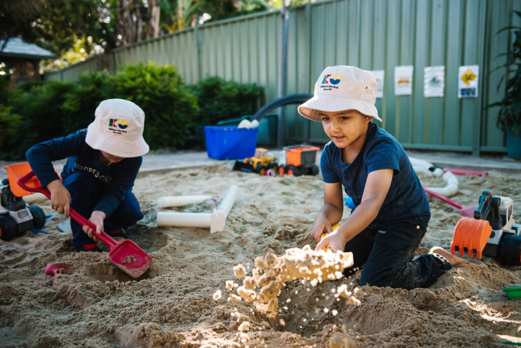 Children digging in the sand at KU Karingal childcare