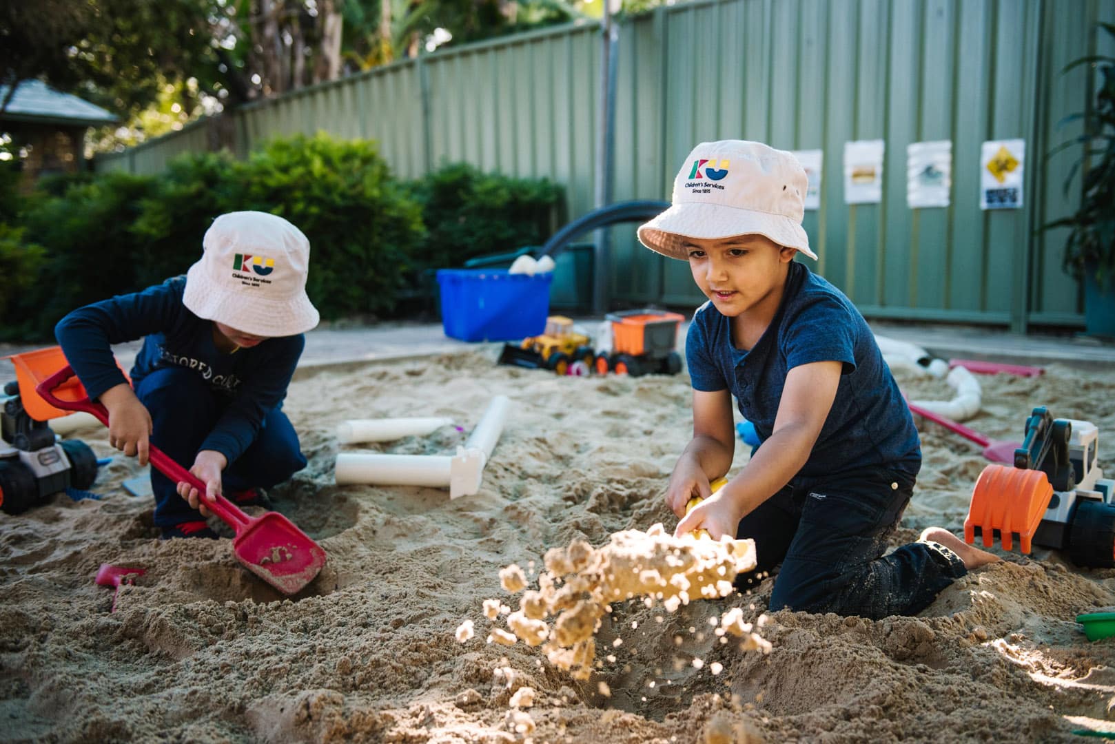 Children digging in the sand at KU Karingal childcare