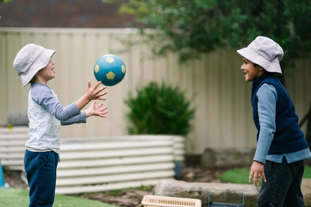Children throwing a ball at KU Gwynneville childcare