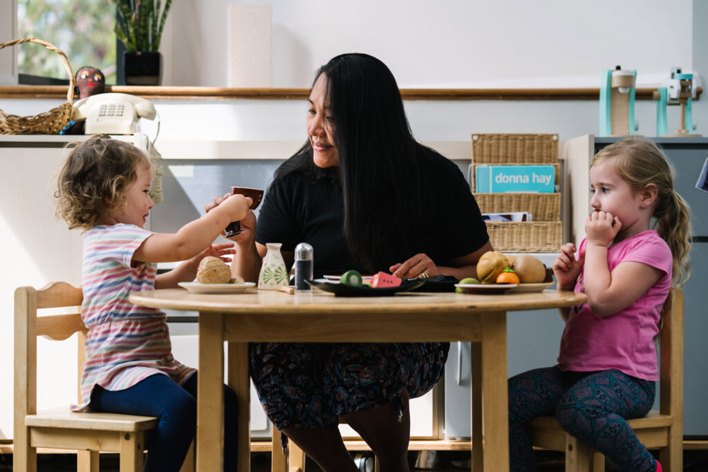 KU Kahibah Road childcare educator and children having a tea party