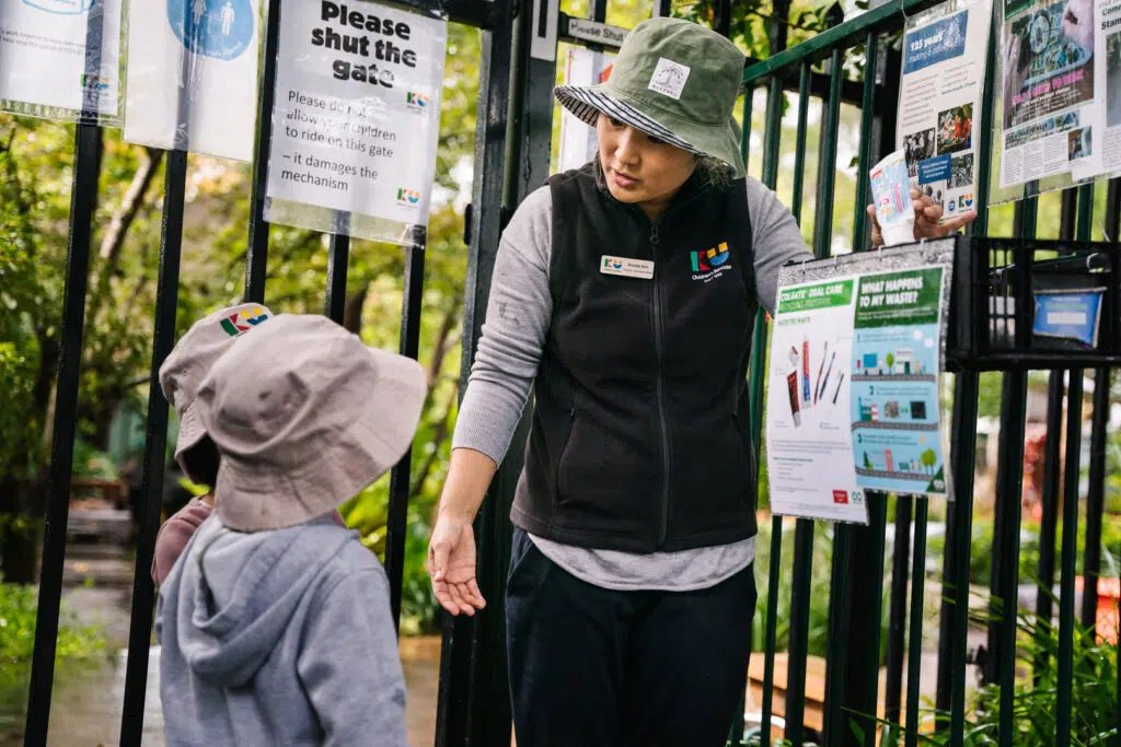 KU Grevillea childcare educator showing children how to recycle
