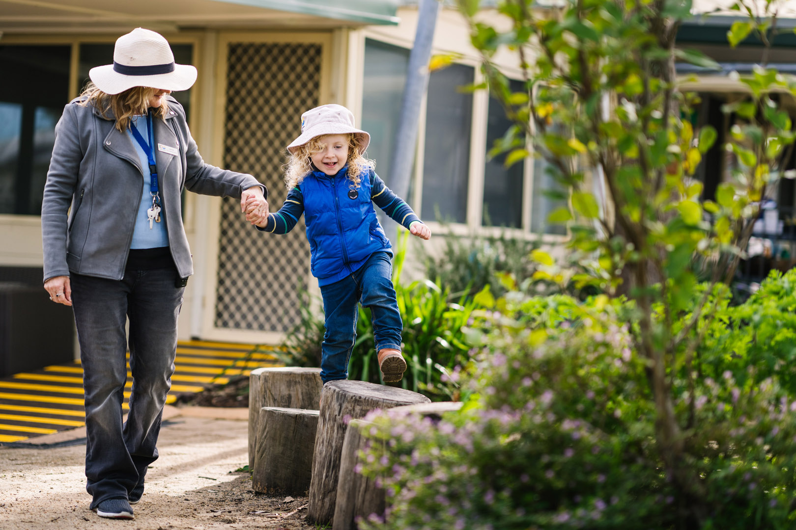Educator and child exploring outdoor environment at Childcare in Tanilba Bay