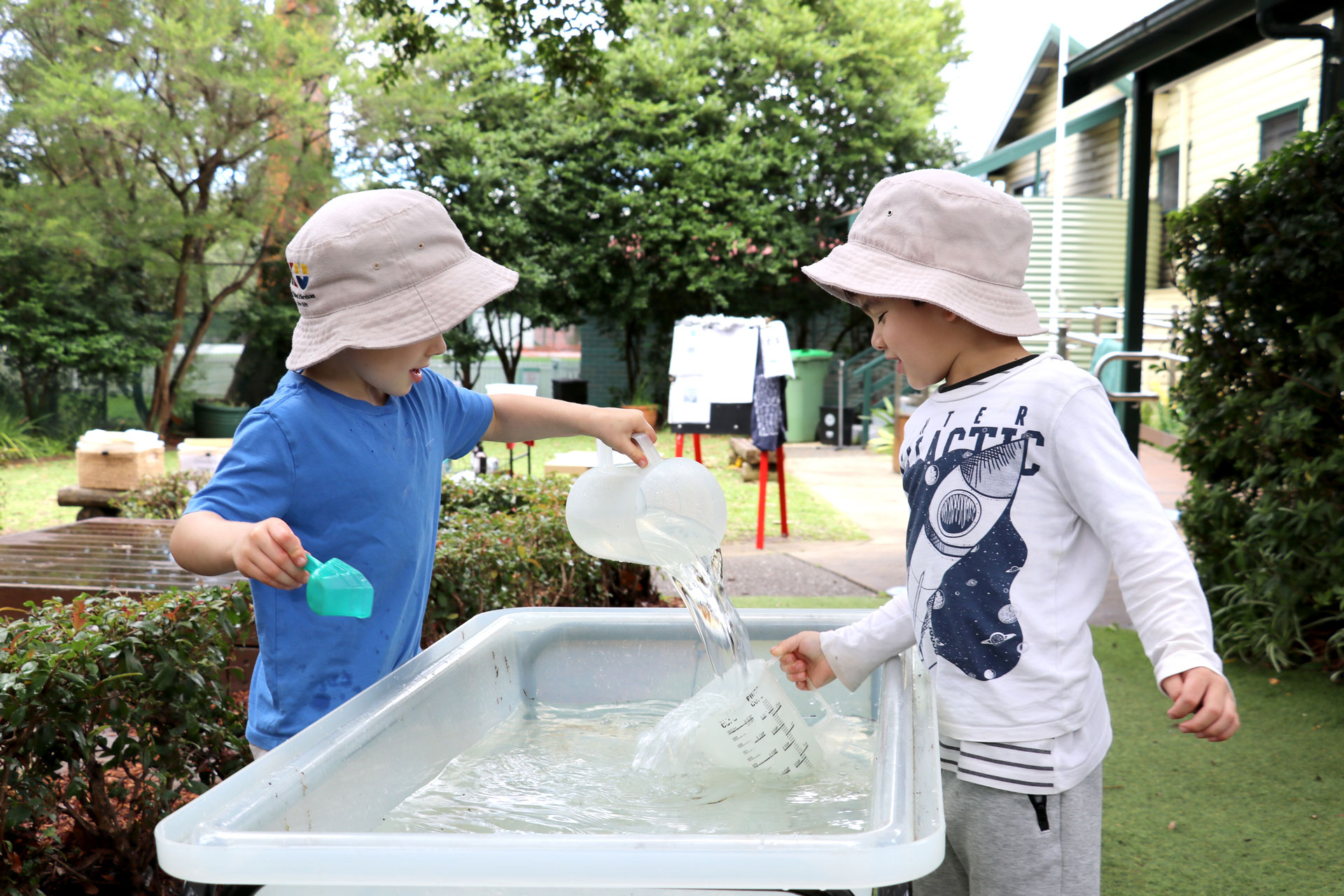 Children playing with water at Killara childcare