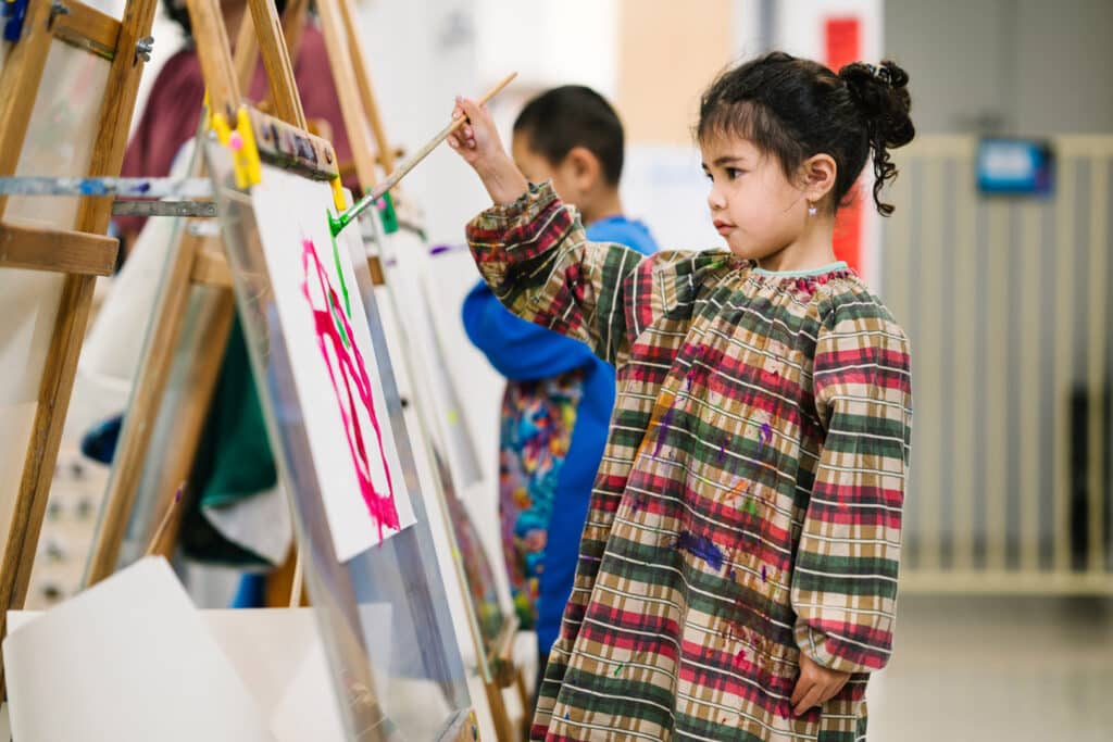 Child painting at KU Knoxfield childcare