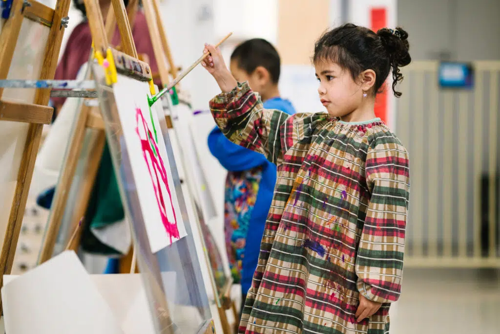 Child painting at KU Knoxfield childcare