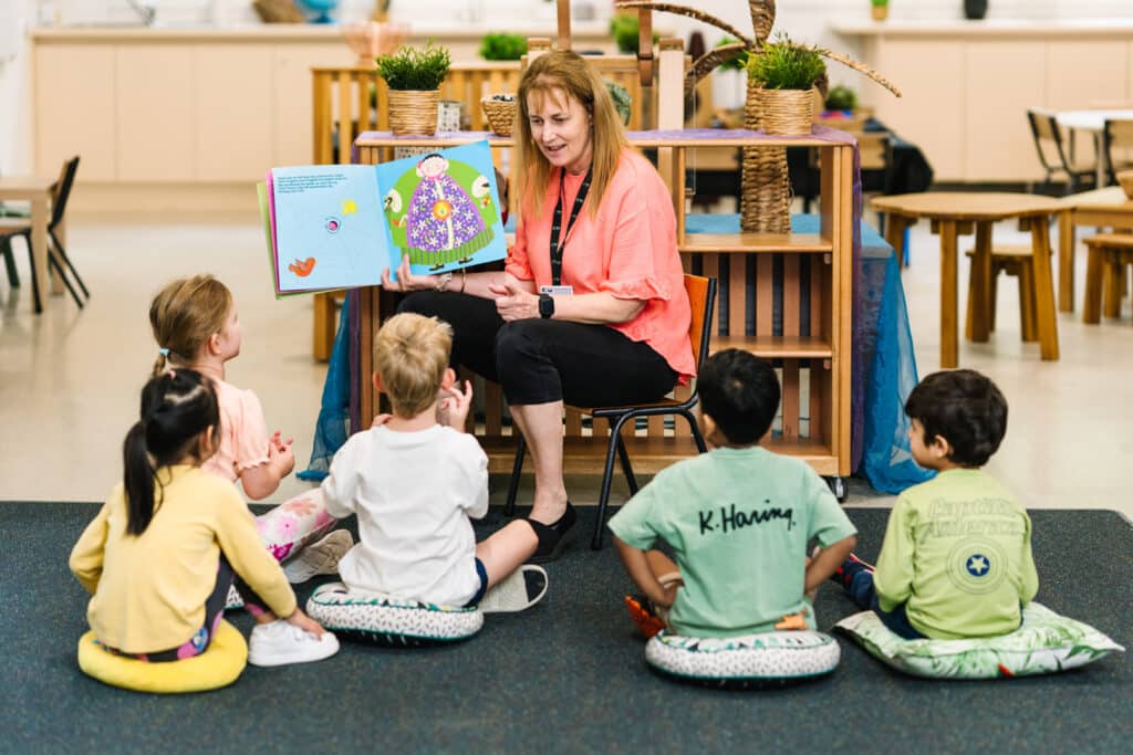 Educator reading to children at KU Knoxfield childcare