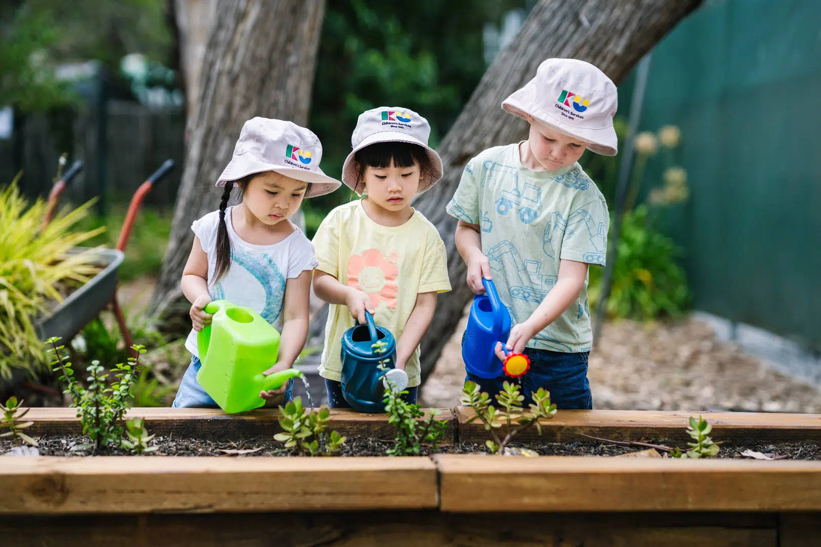 Children gardening at KU Knoxfield childcare