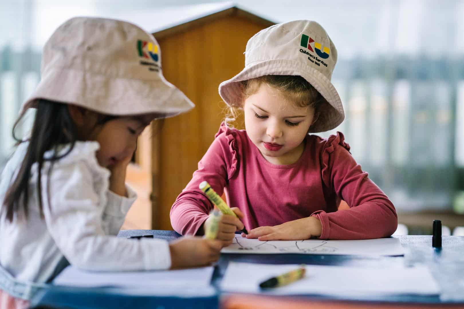 Children drawing pictures at KU Osborne childcare