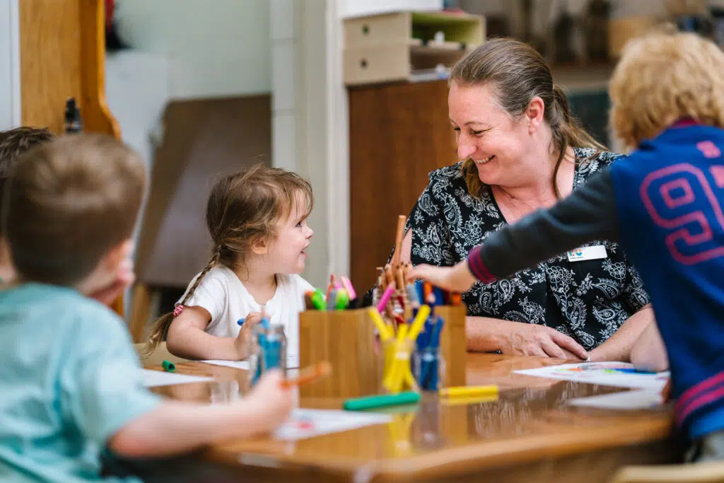 KU Osborne childcare educator drawing pictures with children