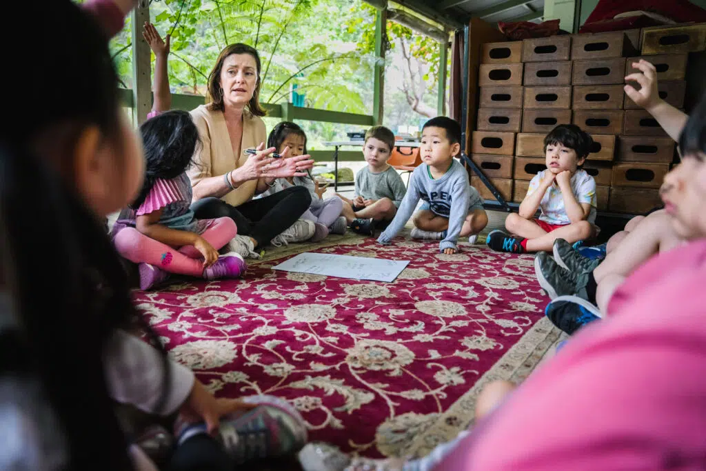 KU Osborne childcare educators and children sitting in a circle