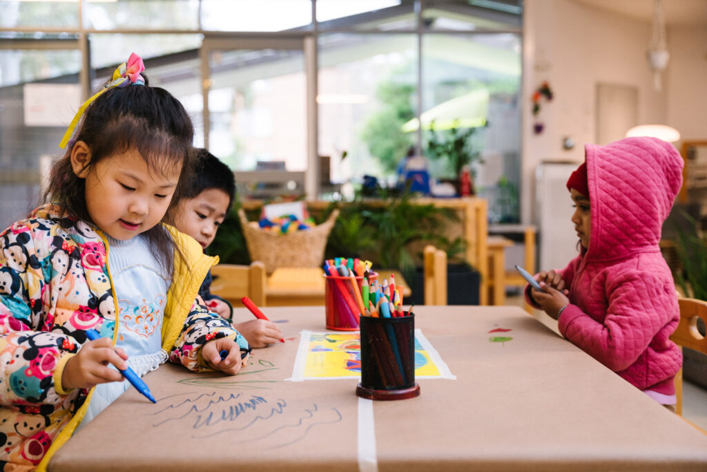 Children drawing pictures at KU Liverpool childcare